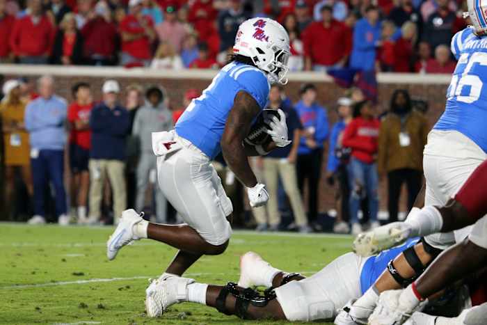 Ole Miss Rebels running back Quinshon Judkins (4) runs during their game against the Arkansas Razorbacks at Vaught-Hemingway Stadium Saturday.